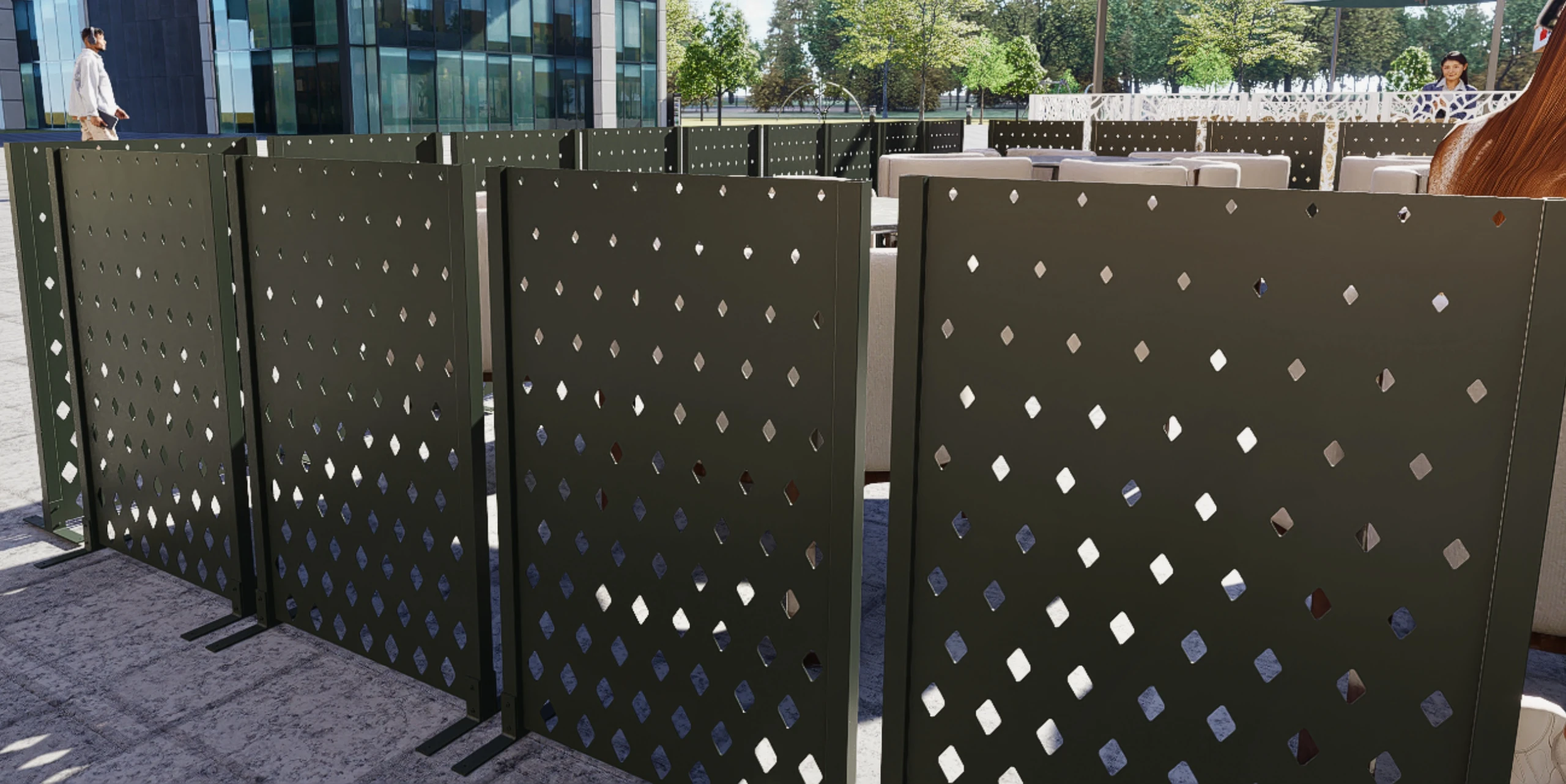 Wizualizacja pokazuje zestaw ciemnych paneli z ażurowymi otworami ustawionych na zewnętrznym tarasie w przestrzeni miejskiej.